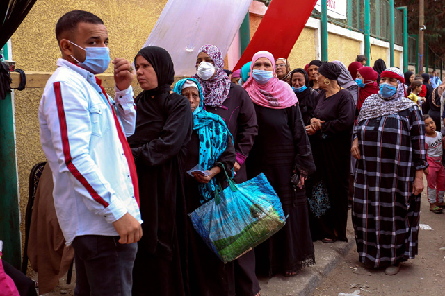 Egyptians wait in line at a polling station to vote in the second phase of a parliamentary election, in the capital Cairo on Saturday (AFP photo)