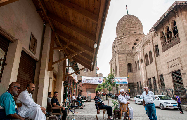 Men sit at a cafe by the 15th century Sultan Qaitbay mosque complex in the ‘Desert of the Mamluk’ (City of the Dead) area of Egypt’s capital Cairo on November 1 (AFP photo)