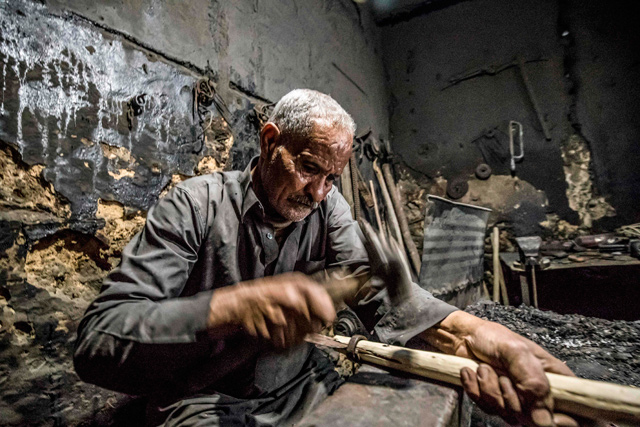   Ibrahim Mohamed, a sheikh of the Haddadin (blacksmiths) tribe and a respected figure in Siwa, works at his workshop in Egypt’s western desert oasis, some 600 kilometres from the capital, on November 6 (AFP photo)