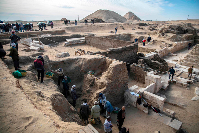 Workers excavate a site during the official announcement of the discovery by an Egyptian archaeological mission of a new trove of treasures at Egypt's Saqqara necropolis south of Cairo, on Sunday (AFP photo)