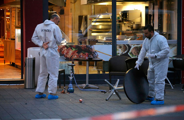 Police forensic experts work at the scene where a 21-year-old Syrian refugee killed a woman with a machete and injured two other people in the city of Reutlingen, Germany, Sunday (Reuters photo)