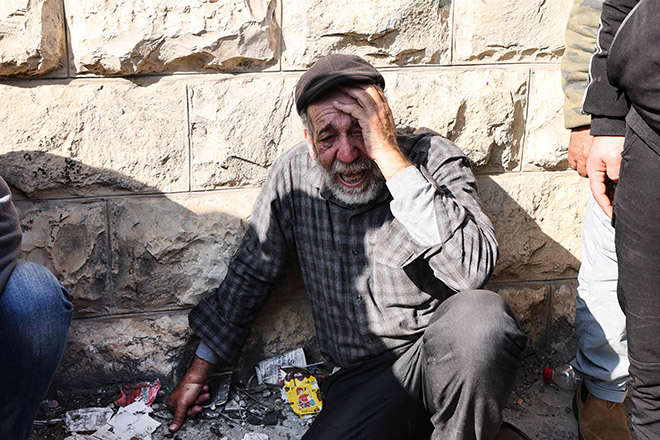 An elderly Palestinian man mourns the death one of the nine reported victims killed during an Israeli raid on the West Bank's Jenin refugee camp, as they begin his funeral procession in the city on Thursday (AFP photo by Jaafar Ashtiyeh)