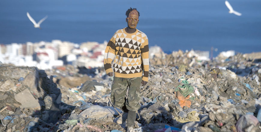 A young migrant searches for objects and food in a garbage dump in Fnideq, northern Morocco, the last stop on the African continent for thousands of migrants who spend months or years trying to reach Europe (AFP photo)