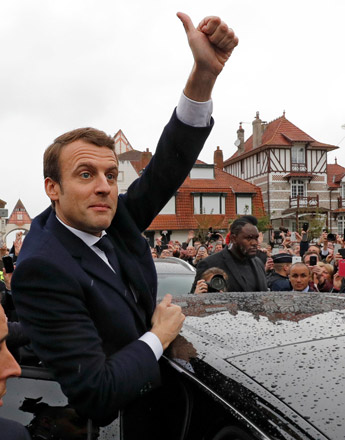French presidential election candidate Emmanuel Macron, head of the political movement En Marche !, or Onwards !, gives thumb up to supporters as he leaves a polling station after voting in the the second round of 2017 French presidential election, in Le Touquet, France, on Sunday (Reuters photo)