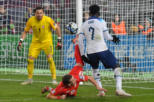 North Macedonia’s defender #08 Ezgjan Alioski (left) fights for the ball with England’s midfielder #07 Bukayo Saka (right) during the UEFA Euro 2024 group C qualification football match between North Macedonia and England at National Arena ‘Todor Proeski’ in Skopje on Monday (AFP photo)