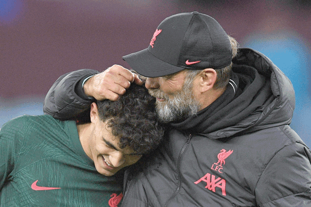 Liverpool's German manager Jurgen Klopp (right) congratulates Liverpool's Spanish defender Stefan Bajcetic at the end of the English Premier League football match between Aston Villa and Liverpool at Villa Park in Birmingham, central England, on Monday (AFP photo)