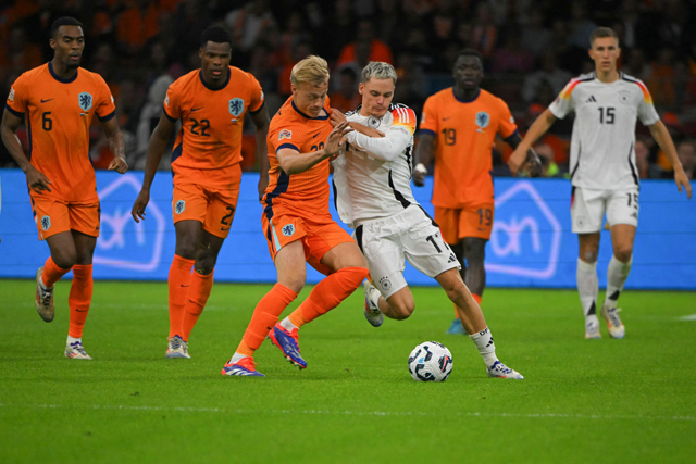 Netherlands’ defender #20 Jan Paul van Hecke fights for the ball with Germany’s midfielder #17 Florian Wirtz during the UEFA Nations League football match between Netherlands and Germany at the Johan Cruyff Arena in Amsterdam, on Tuesday (AFP photo)