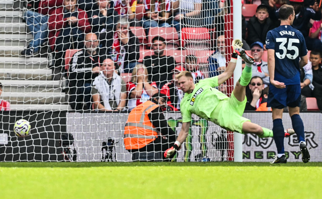 Manchester United's Argentinian midfielder #17 Alejandro Garnacho (unseen) scores his team third goal past Southampton's English goalkeeper #30 Aaron Ramsdale during the English Premier League football match between Southampton and Manchester United at St Mary's Stadium in Southampton, southern England, on Saturday (AFP photo)