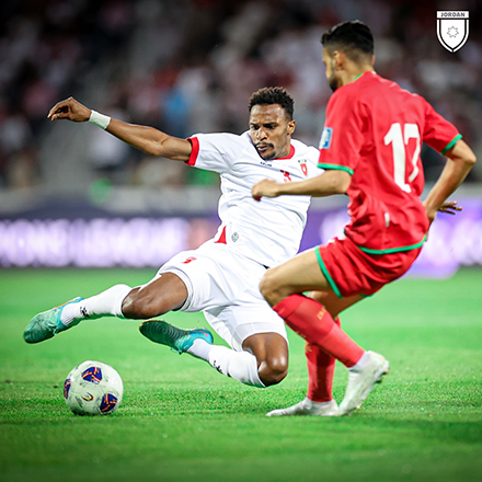Abdullah Nasib tackles the ball in front of Oman's Ali Al Busaidi (Photo of Jordan Football Association)