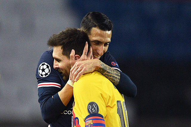 Paris Saint-Germain's Argentinian midfielder Angel Di Maria (right) hugs Barcelona's Argentinian forward Lionel Messi after the UEFA Champions League round of 16 second leg football match between Paris Saint-Germain (PSG) and FC Barcelona at the Parc des Princes stadium in Paris, on Wednesday (AFP photo)