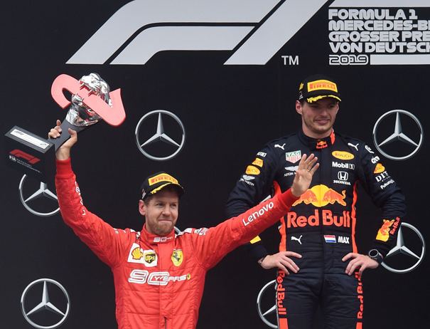 Second placed Ferrari’s German driver Sebastian Vettel and winner Red Bull’s Dutch driver Max Verstappen celebrate on the podium after the German Formula One Grand Prix at the Hockenheim racing circuit in southern Germany on Sunday (AFP photo by Christof Stache)