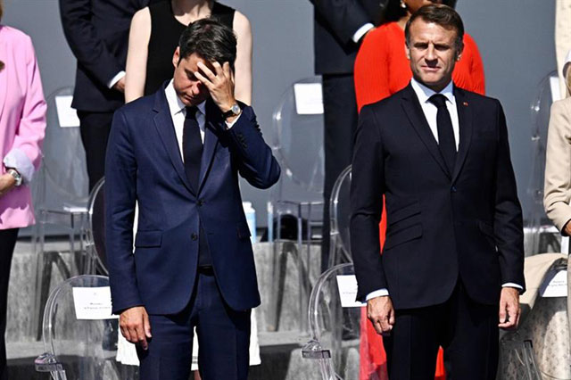 France s Prime Minister Gabriel Attal (left) reacts next to France s President Emmanuel Macron during the Bastille Day military parade on the Avenue Foch in Paris (AFP photo)
