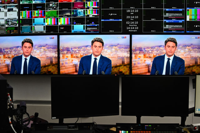 This photograph of monitors in a media control room at AFP headquarters in Paris, shows resigning French Prime Minister Gabriel Attal during a televised interview broadcasted on the French TV channel TF1’s evening news program on Tuesday (AFP photo)