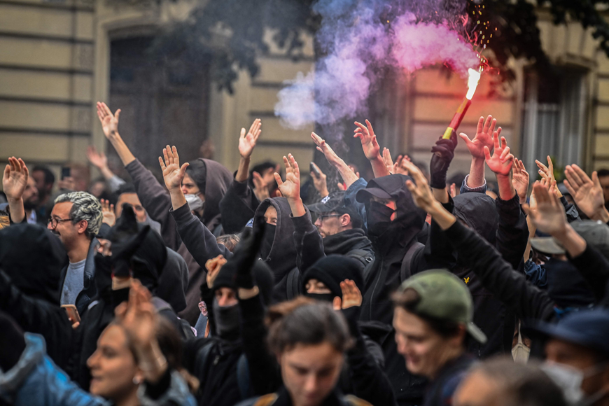 Protesters burn a flare during a demonstration in Paris, on Tuesday (AFP photo)