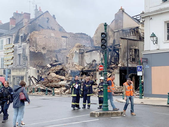 Emergency personnel survey the scene of a burntout building, which housed a pharmacy, in Montargis, some 100km south of Paris on Saturday (AFP photo)