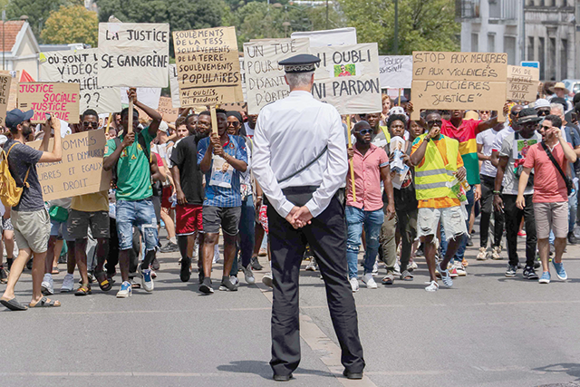 Angouleme's police commissioner Jean-Luc Taltavull (centre) faces marchers as they rally in tribute to Alhoussein Camara in a suburb of Angouleme, western France, on Saturday (AFP photo)