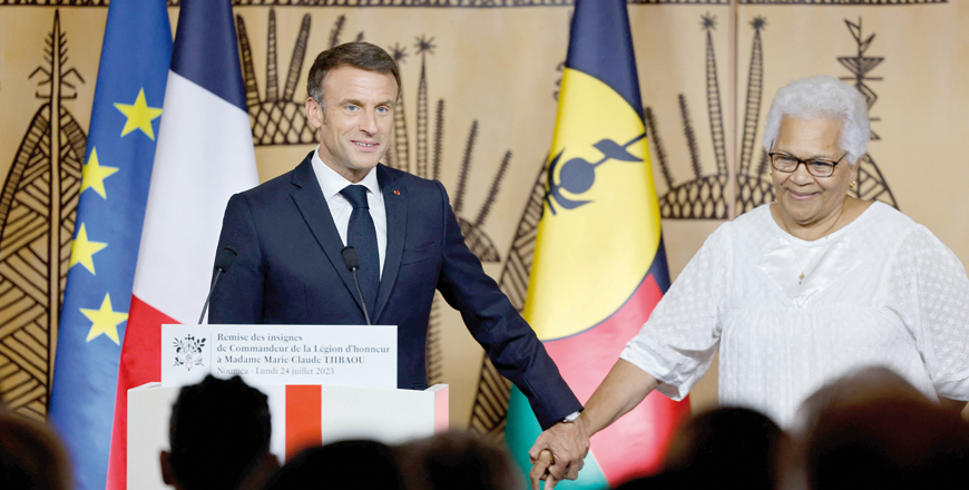 France's President Emmanuel Macron presents the insignia of Commander of the Legion of Honour to Marie-Claude Tjibaou, widow of the assassinated Kanak leader Jean-Marie Tjibaou, during a ceremony in Noumea on Monday (AFP photo)