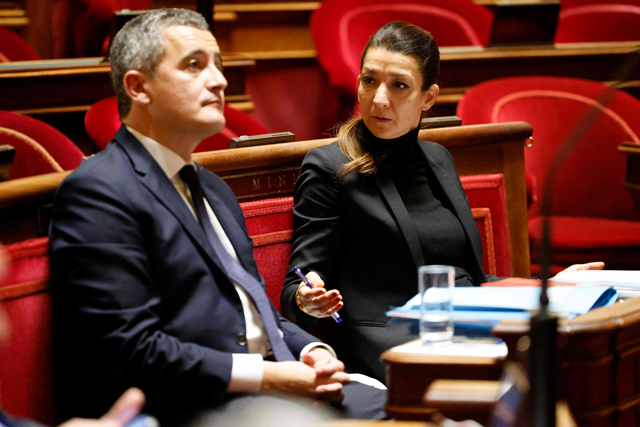 French Junior Minister for Cities Sabrina Agresti-Roubache (right) gestures towards French Interior Minister Gerald Darmanin during a debate on the French Government’s immigration bill at the French Senate in Paris on Monday (AFP photo)