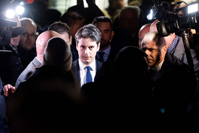 Newly appointed French Prime minister Gabriel Attal (centre) speaks with local residents during a visit to Clairmarais, northern France, on Tuesday (AFP photo)
