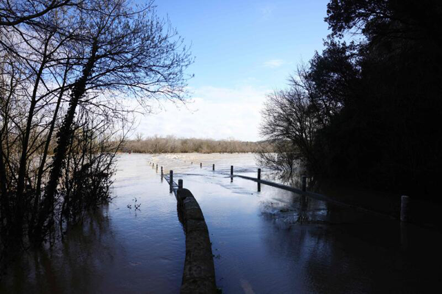 A bridge submerged by the flooded Gard river is pictured in Dions, on Sunday, following heavy rain (AFP file photo) 