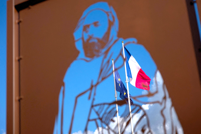 French and European flags fly in front of a sculpture in tribute to Algerian national hero Abdelkader, titled ‘Passage Abdelkader’, created by artist Michel Audiard, in Amboise, central France, on Saturday (AFP photo)