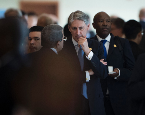 Britain's Finance Minister Philip Hammond (centre) speaks with delegates after taking part in a ‘family photo’ with other ministers and central bank chiefs at the G-20 finance ministers meeting in Chengdu in China's Sichuan province on Thursday (AFP photo)