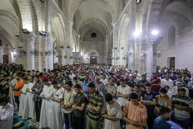 Gazan Muslims perform Taraweeh prayer on Laylat Al Qadr, the night when the first verses of the Koran were revealed, at the Great Mosque of Gaza, also known as the Great Omari Mosque, in Gaza City on Wednesday (Anadolu Agency photo)