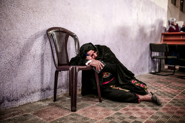A Palestinian woman waits for passport control at the Rafah border gate after Rafah crossing opens for 3 days under Palestinian Authority for 1st time in 10 years on Saturday in Rafah, Gaza (Anadolu Agency photo)