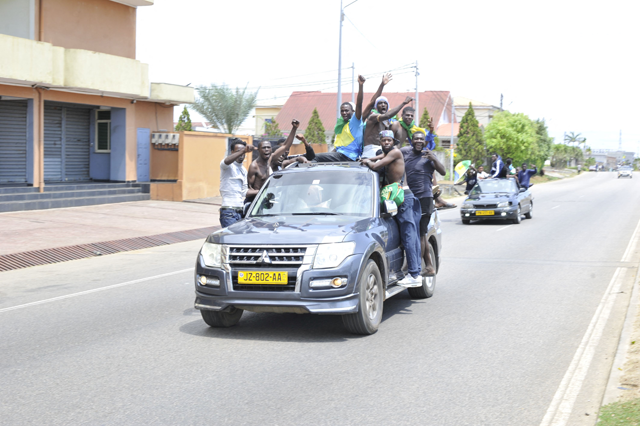 Residents driving in a vehicle celebrate and hold a Gabon national flag in Libreville on Wednesday (AFP photo)