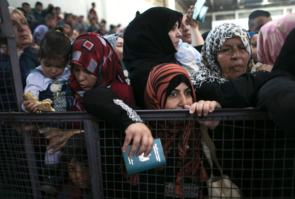 Palestinians wait at the Rafah border crossing with Egypt, in the southern Gaza Strip, after it was opened for two days by Egyptian authorities, on Wednesday (AFP photo)
