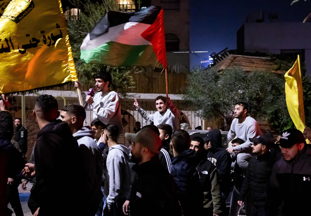 Palestinian prisoners (wearing grey jumpers) cheer among supporters and relatives after being released from Israeli jails in exchange for Israeli hostages released by Hamas from the Gaza Strip, in Ramallah in the occupied West Bank on Sunday (AFP photo)