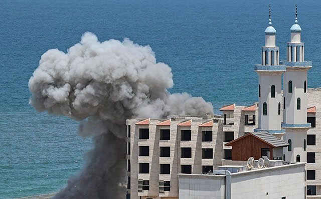 Smoke billows from the port of Gaza following an Israeli naval bombardment on Monday (AFP photo)
