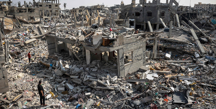People inspect the damage amid the rubble of buildings destroyed during Israeli bombardment in Khan Yunis, on the southern Gaza Strip on Tuesday, as fighting continues between Israel and the Hamas (AFP photo)