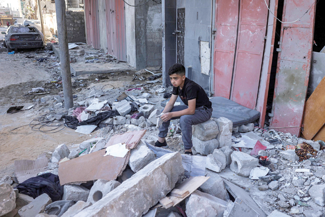 A boy sits amidst rubble at the site of a building that was hit by Israeli bombardment in Rafah in the southern Gaza Strip on May 8, 2024 amid the ongoing Israeli offensive against the coastal enclave  (AFP photo)