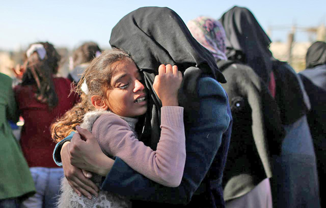 The sister of Palestinian boy Ahmed Abed is comforted as she mourns during his funeral in Khan Younis, in the southern Gaza Strip, on Wednesday  (Reuters photo)