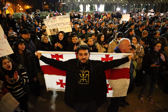 Georgian opposition supporters rally calling for government to follow 'pro-Western' path in Tbilisi on Thursday (AFP photo)