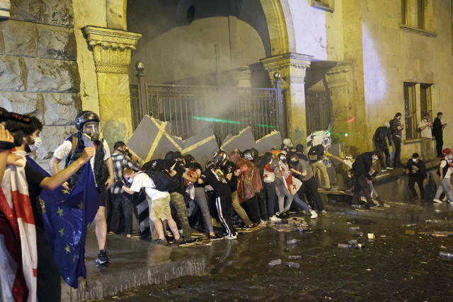 Demonstrators attempt to block the side entrance of the Georgian parliament during a rally against a controversial ‘foreign influence’ bill, which Brussels warns would undermine Georgia’s European aspirations, in Tbilisi on Wednesday (AFP photo)
