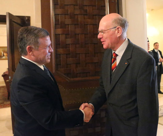 His Majesty King Abdullah shakes hands with German Bundestag President Norbert Lammert in Amman on Sunday (Photo courtesy of Royal Court)