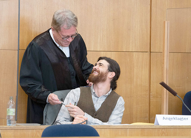 Defendant Franco A (right), a German soldier who allegedly plotted to attack prominent politicians while posing as a Syrian refugee, talks with his lawyer Johannes Hock at the start of his trial in Frankfurt am Main, western Germany, on Thursday (AFP photo)