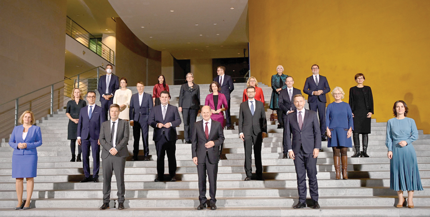 Newly elected German Chancellor Olaf Scholz (third from left in the first row) and his ministers pose for a group photo at the first meeting of the new Cabinet at the Chancellery in Berlin on Wednesday (AFP photo)