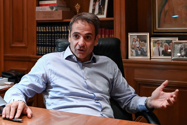 Greek Prime Minister Kyriakos Mitsotakis gives an interview to AFP journalists in Athens on Tuesday (AFP photo)