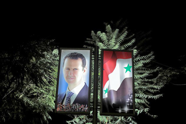 A photo of Syrian President Bashar Assad is seen at a train station in Damascus, Syria, on September 12, 2018 (Reuters photo)