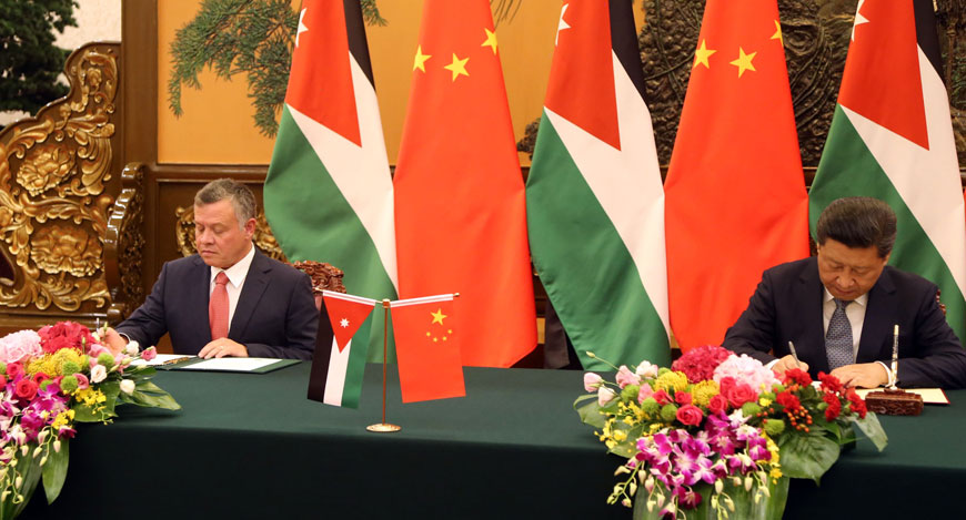 His Majesty King Abdullah and Chinese President Xi Jinping sign a strategic deal in Beijing on Wednesday (Photo courtesy of Royal Court)