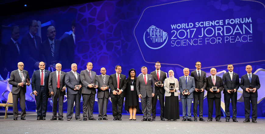 His Majesty King Abdullah poses for a group photo with prominent Jordanian scientists who made remarkable achievements in various fields on Tuesday  (Photo courtesy of Royal Court)