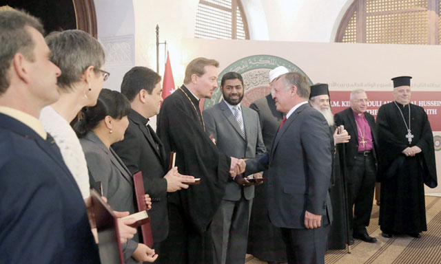 His Majesty King Abdullah shakes hands with the winners of the King Abdullah II World Interfaith Harmony Week award at a ceremony held on Sunday at Al Husseiniya Palace (Photo courtesy of Royal Court)