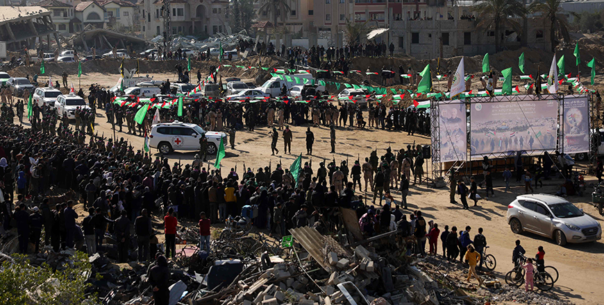 Red Cross vehicles enter an area secured by Palestinian Hamas fighters, before receiving Israeli hostages in Khan Yunis in the southern Gaza Strip on February 15, 2025, as part of the sixth hostage-prisoner exchange 