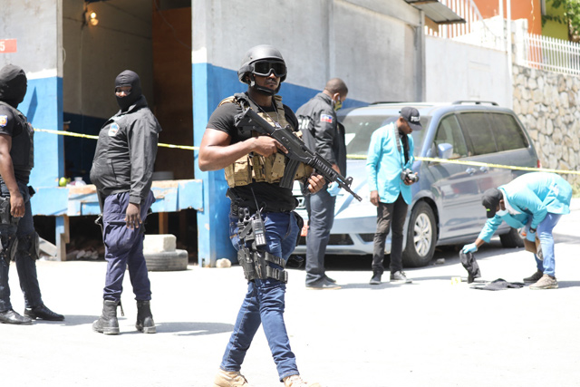Members of the Haitian police and forensics look for evidence outside of the presidential residence on Wednesday in Port-au-Prince, Haiti (AFP photo)
