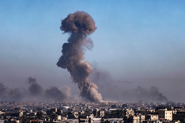 A photo taken from Rafah shows smoke billowing during Israeli bombardment over Khan Yunis in the southern Gaza Strip on Sunday (AFP photo)