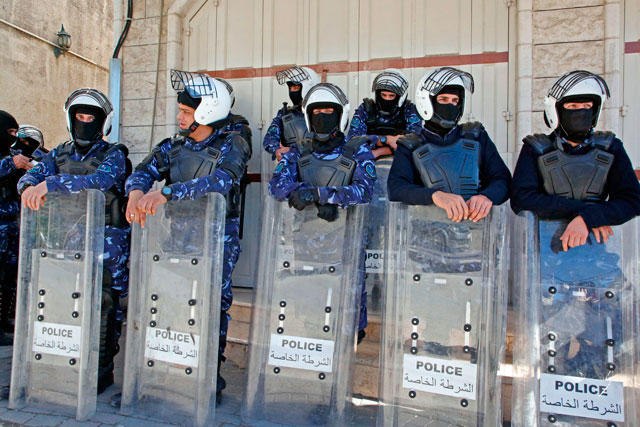 Palestinian security forces gather during a rally by Hamas supporters marking the 31st anniversary of the founding of the Islamist movement, in the occupied West Bank town of Hebron, on Friday (AFP photo)