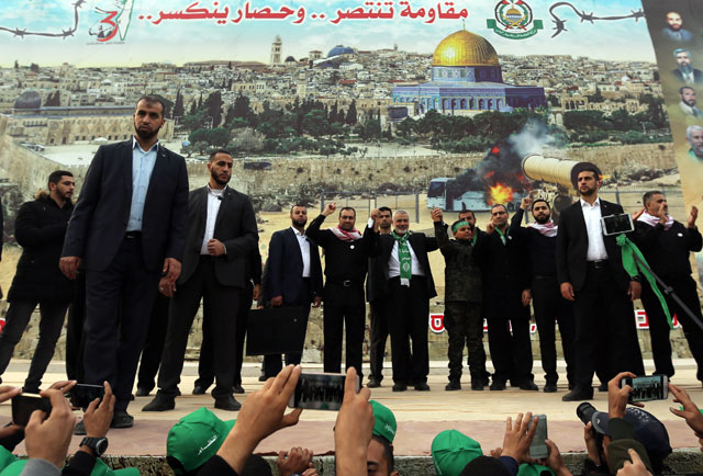 Hamas chief Ismail Haniyeh gestures during a rally marking the 31st anniversary of Hamas’ founding in Gaza City, on Sunday (Reuters photo)